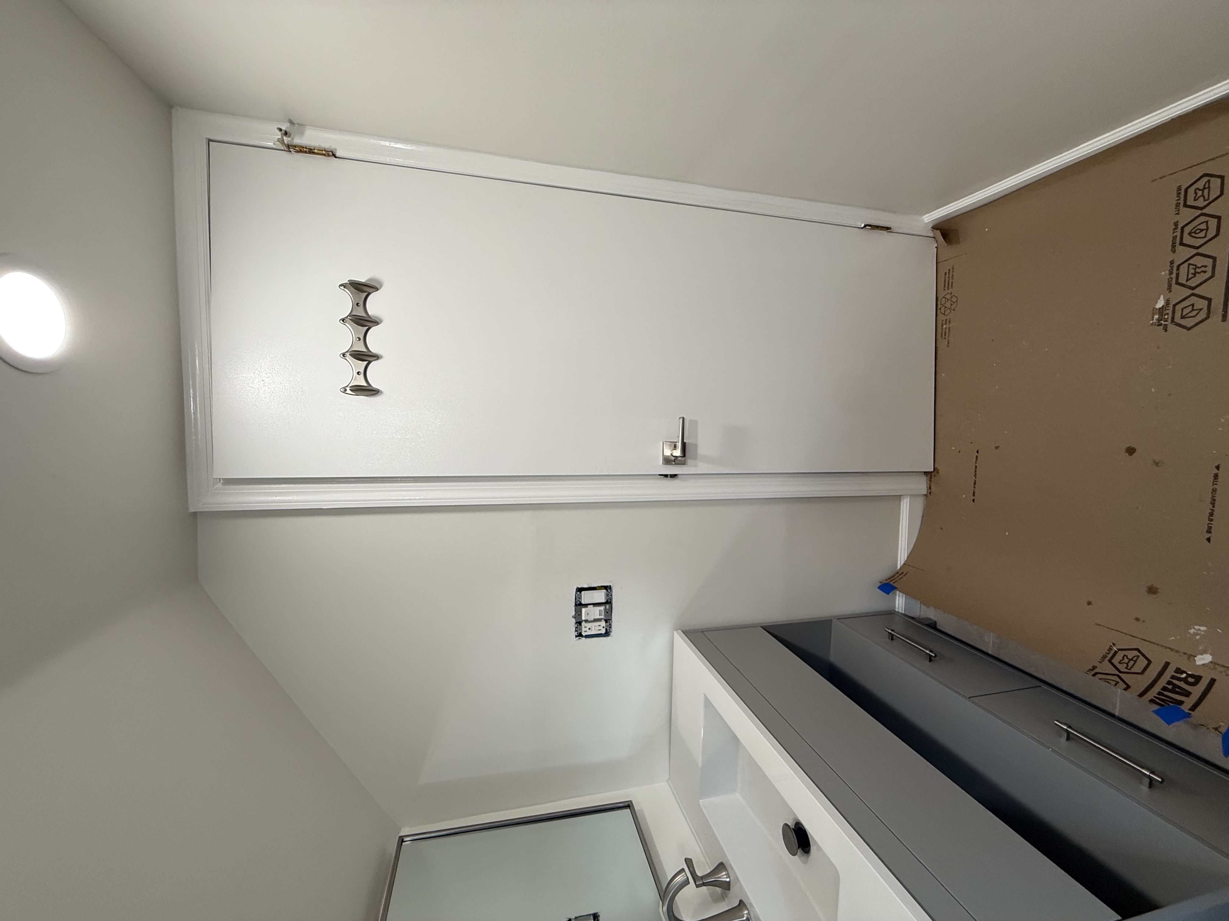Gray bathroom vanity with white countertop and sink after bathroom remodeling in , NJ.