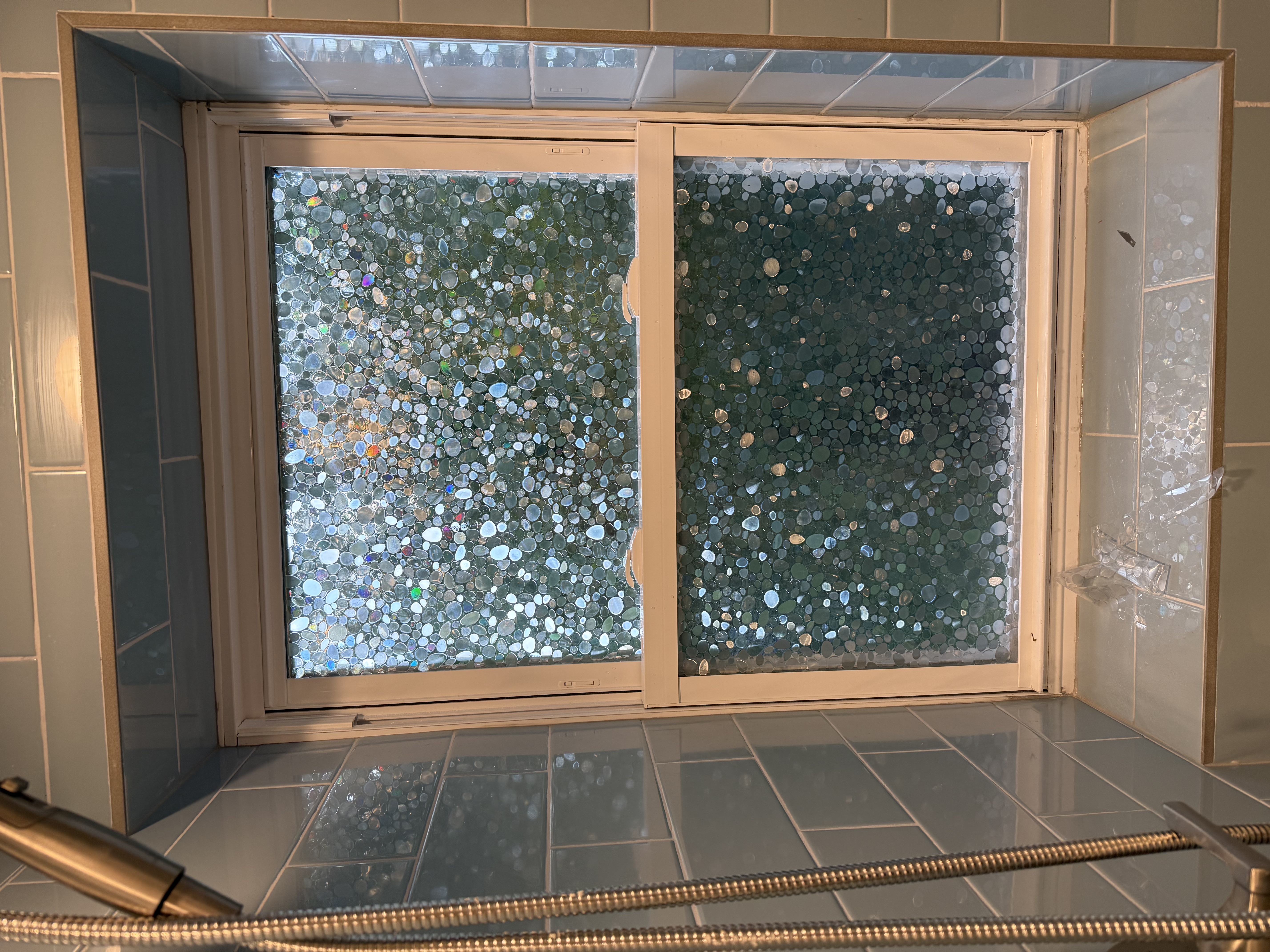 Bathroom featuring blue subway tiles, white window with privacy film after bathroom remodeling in [City], NJ