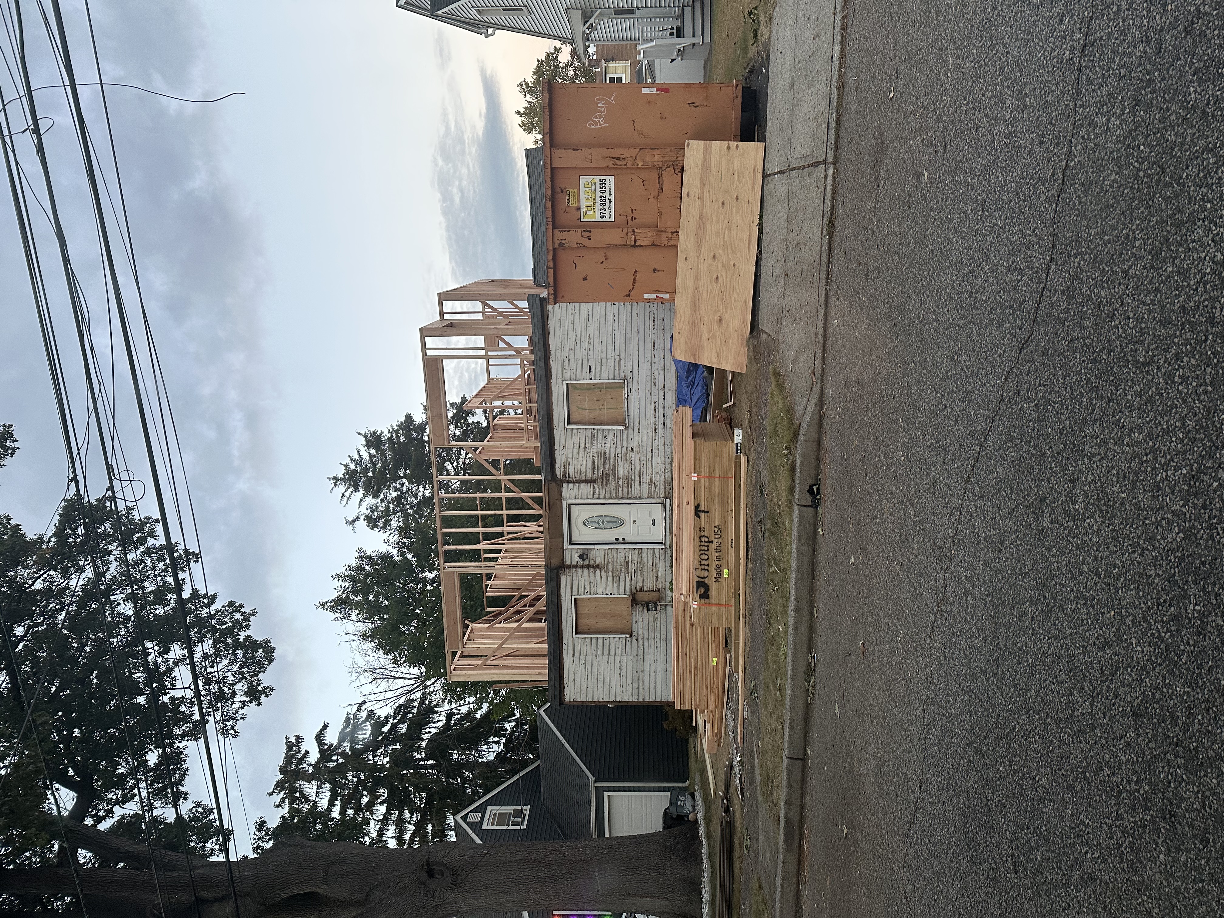 Original single story home before renovation with construction materials