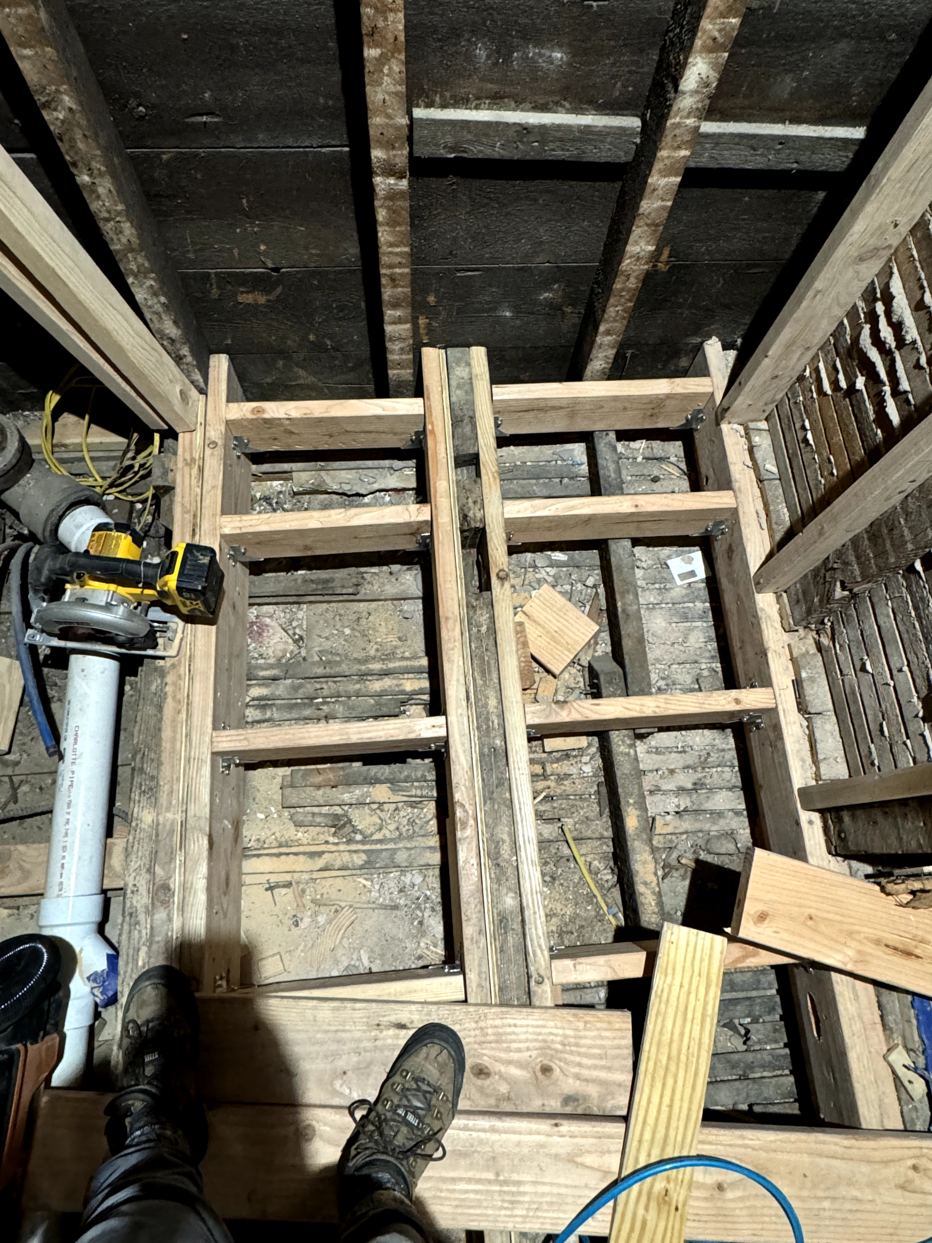 Bathroom Renovation in progress, showing exposed floor joists and subfloor removal in Rahway, NJ.