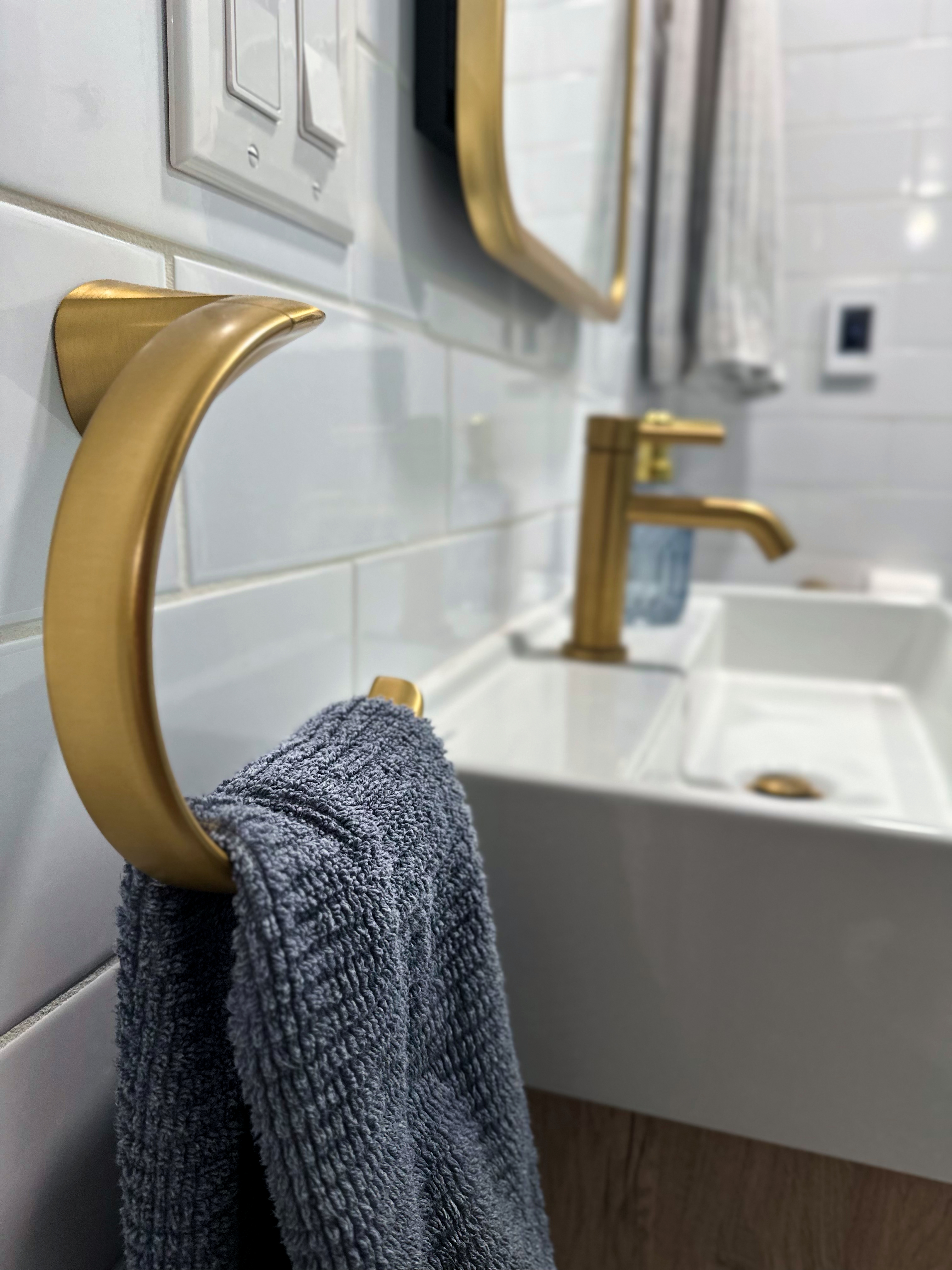 Bathroom with white subway tile, gold fixtures, and sleek vanity after Bathroom Renovation in Rahway, NJ.