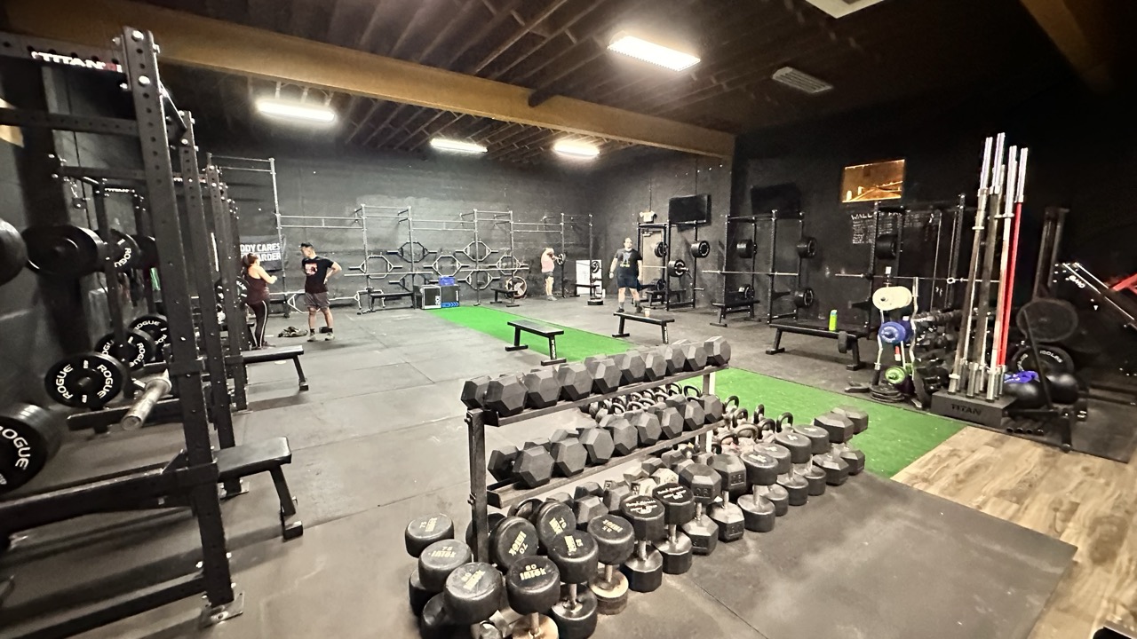 Before photo of a dark and unorganized gym interior