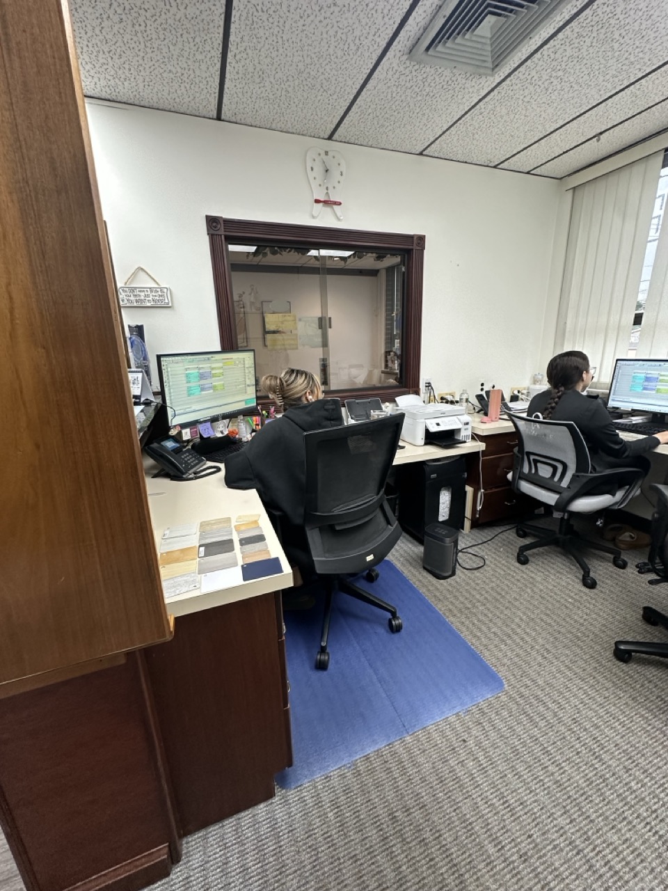 Office workspace before renovation showing cluttered desks
