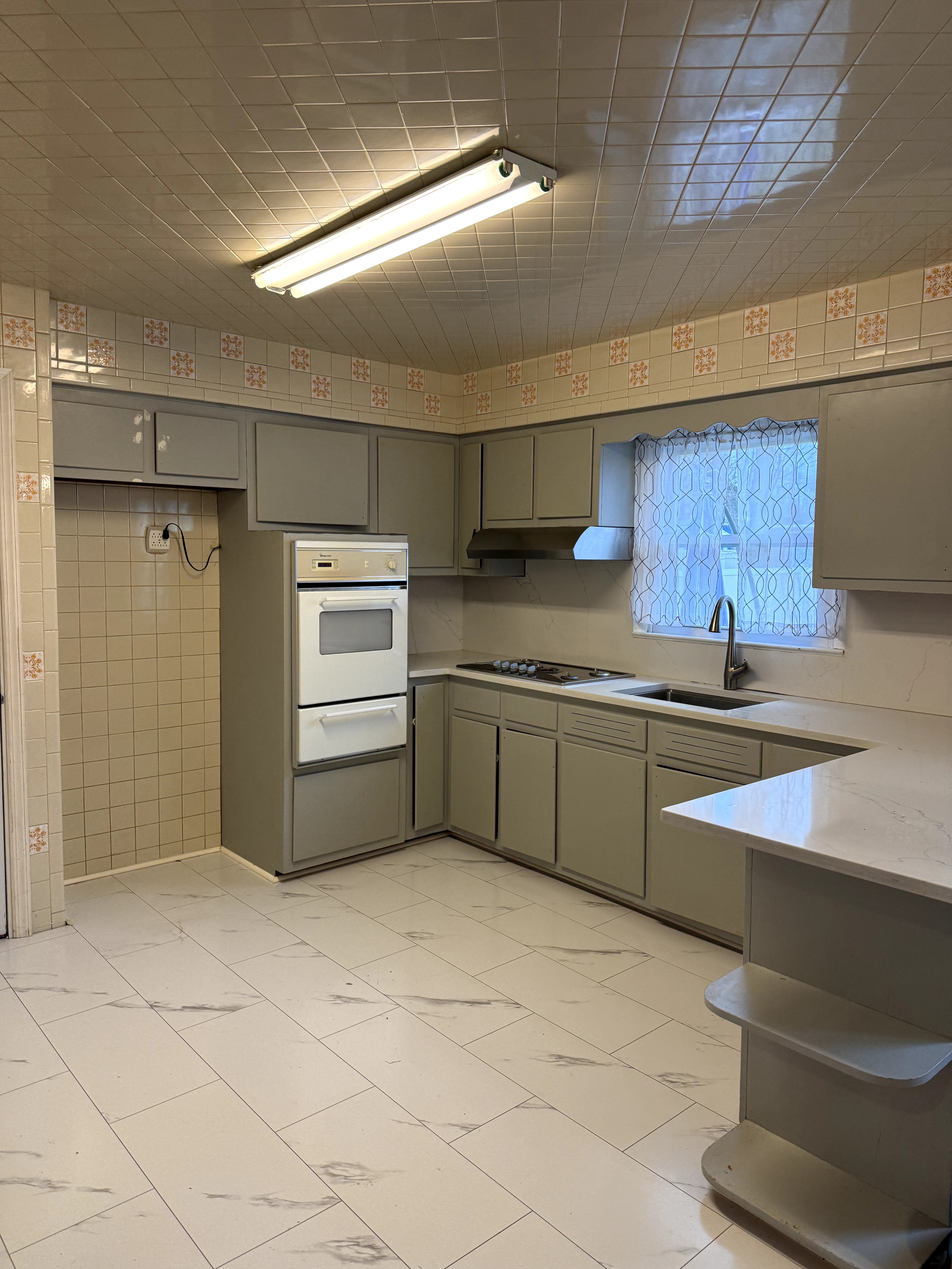Original kitchen with outdated tile and old appliances