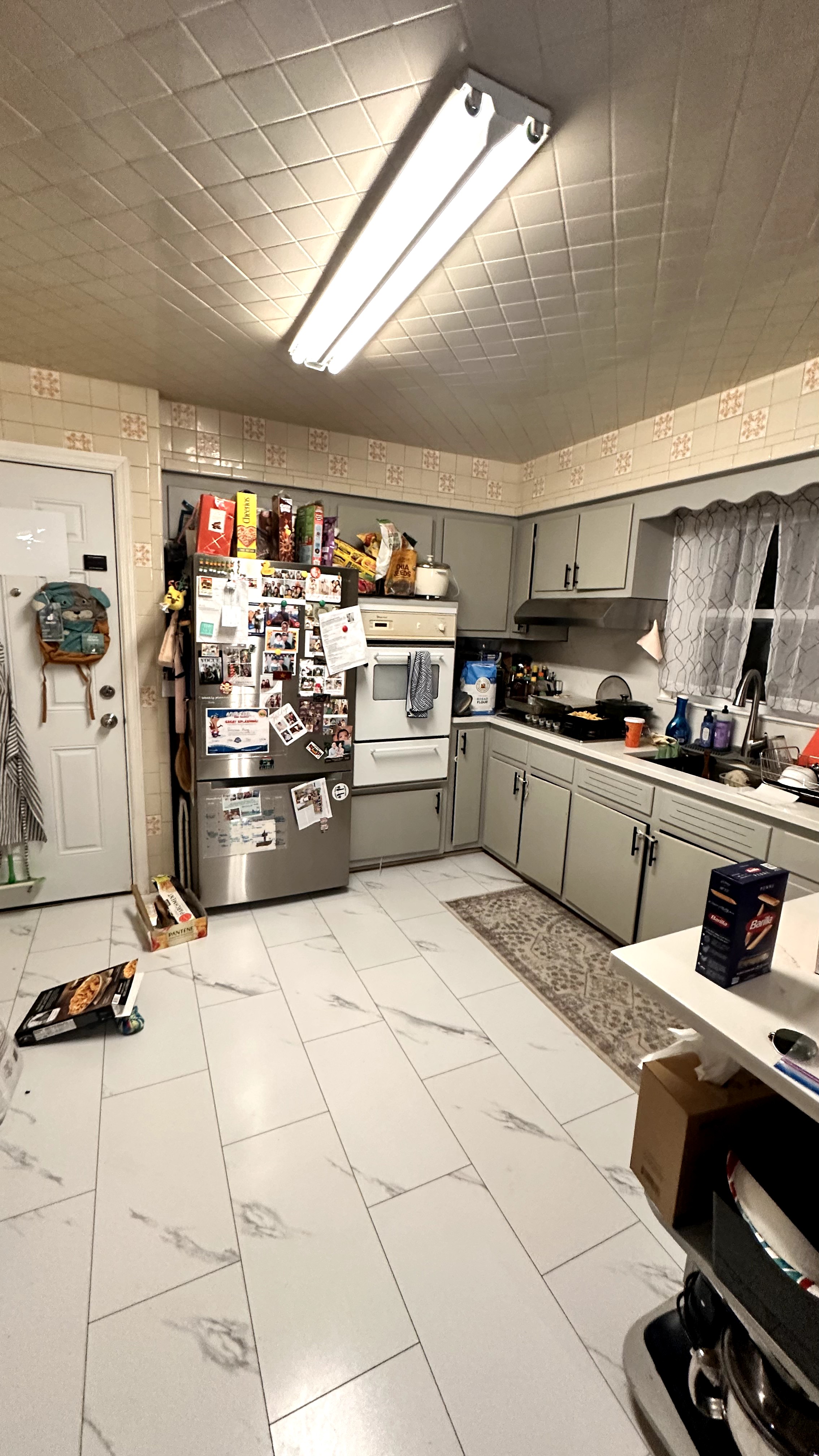 Original kitchen with cluttered counters and old appliances