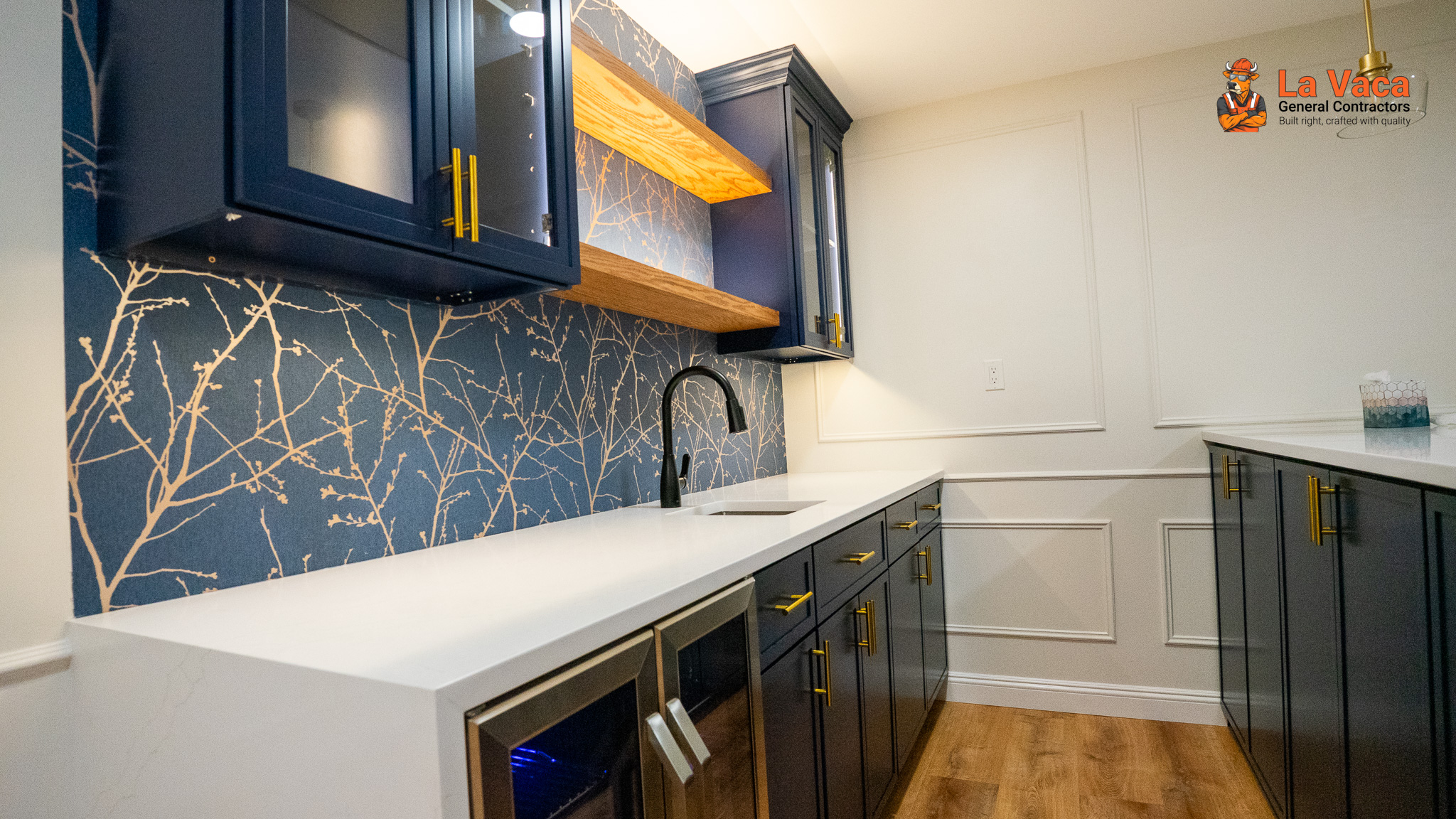 Wet bar with navy cabinets, white quartz counter, & patterned wallpaper after Basement Finishing in Kinnelon, NJ.